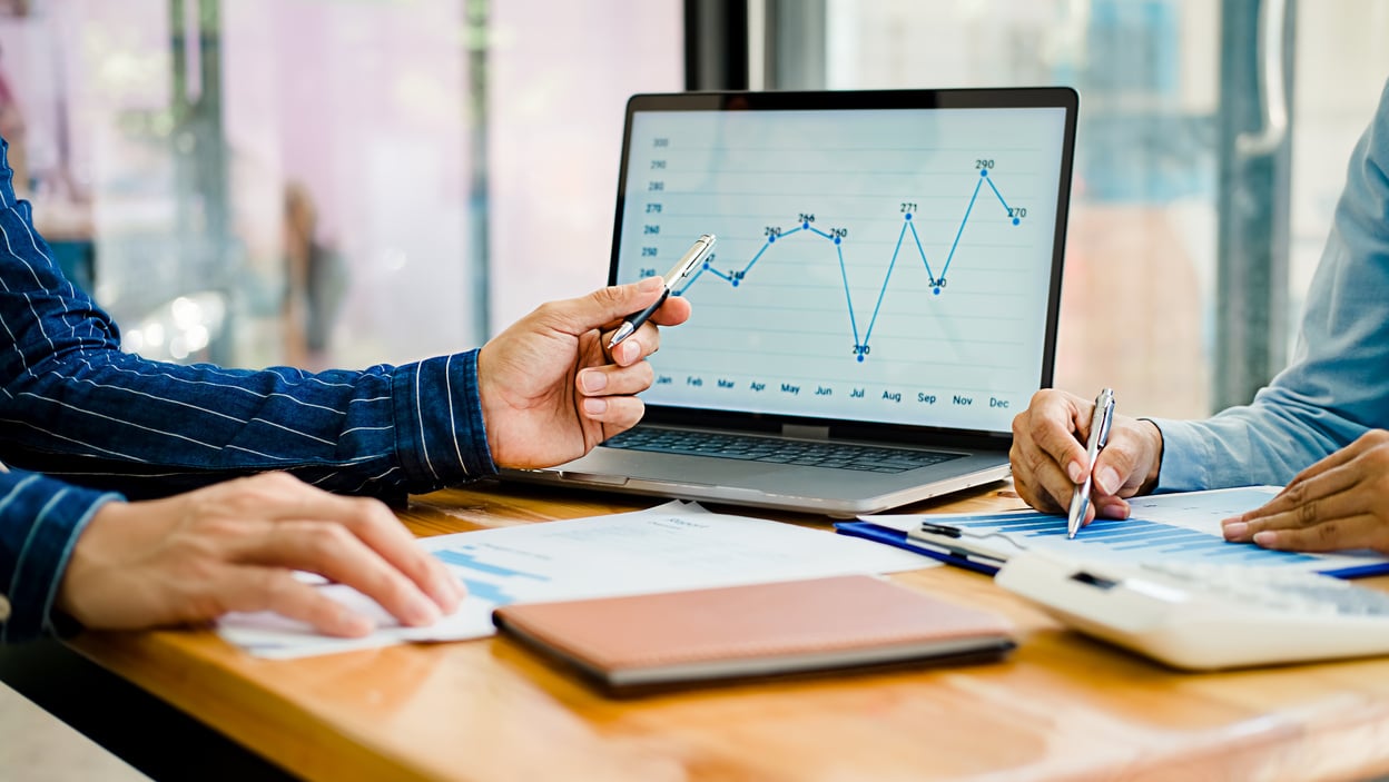 Colleagues Discussing Charts and Graphs in the Office